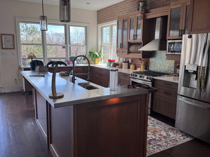 Espresso cabinets with quartz counters and an island
