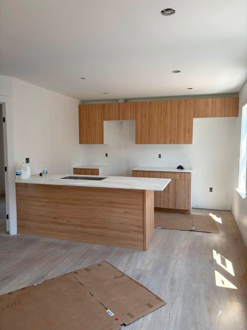 Oak cabinetry with a white quartz island top