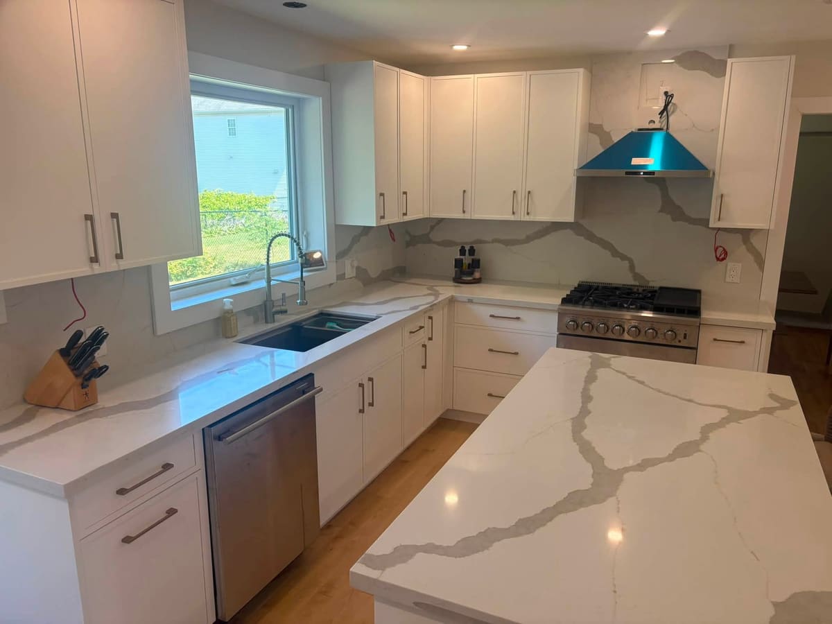 White quartz kitchen counters with a matching full-height backsplash