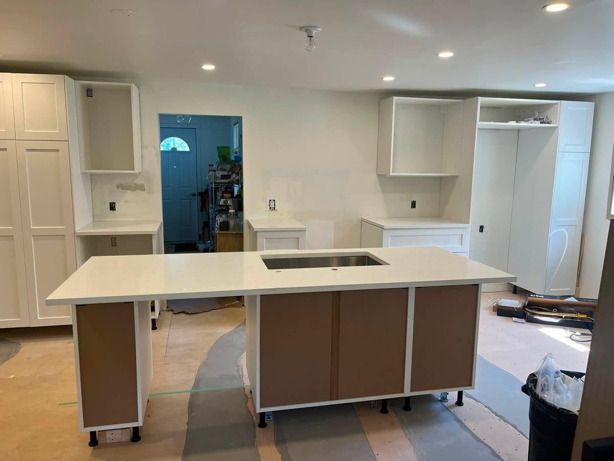 Walnut cabinetry with a white quartz island top
